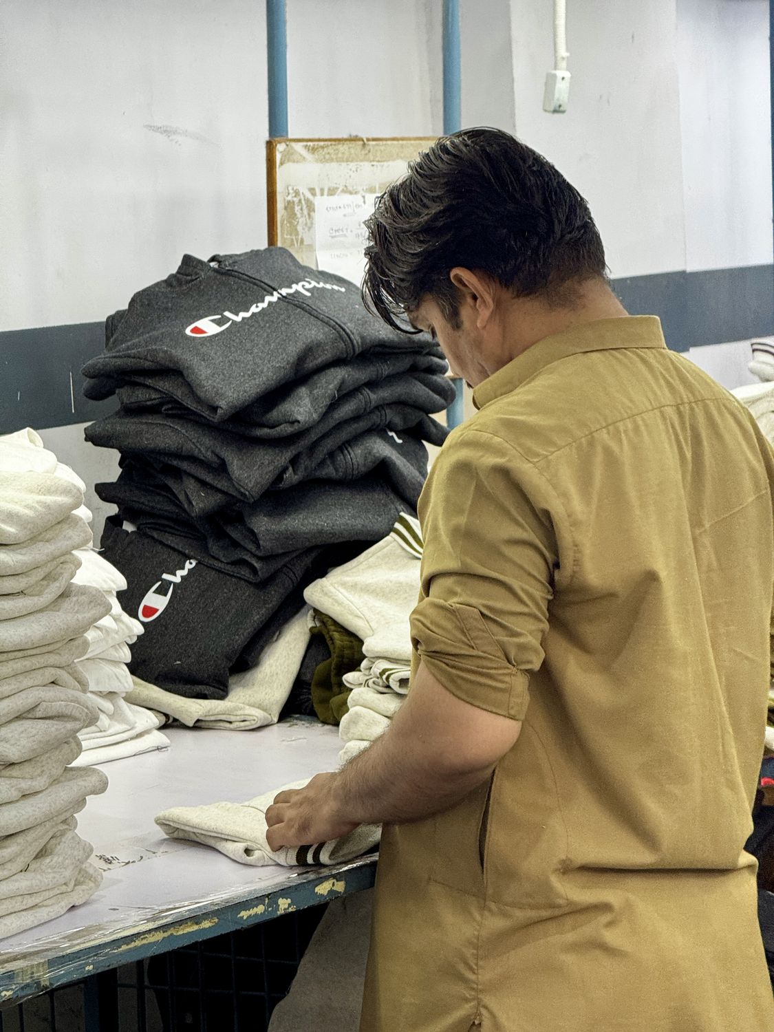 Finished garments, folded — inside the Knitora facility